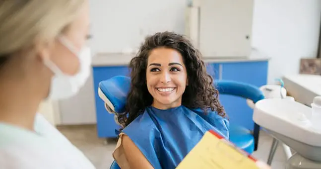 Woman Visiting A General Dentist near Harrison Township MI