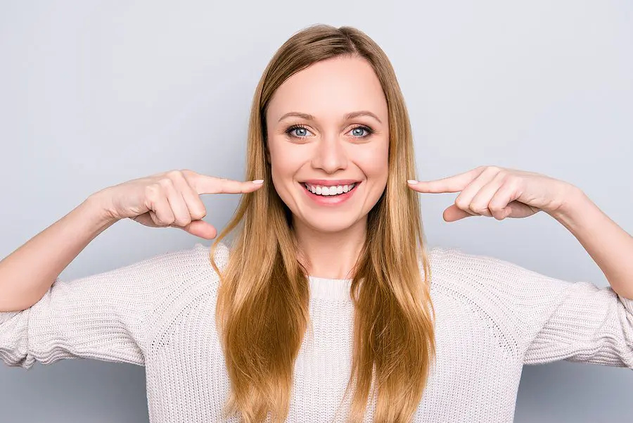 Portrait Of Joyful Satisfied Girl Gesturing Her Beaming White He