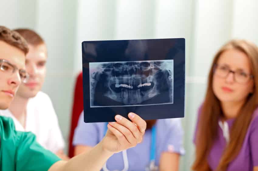 Dentists Holding X-rays For Patient To See