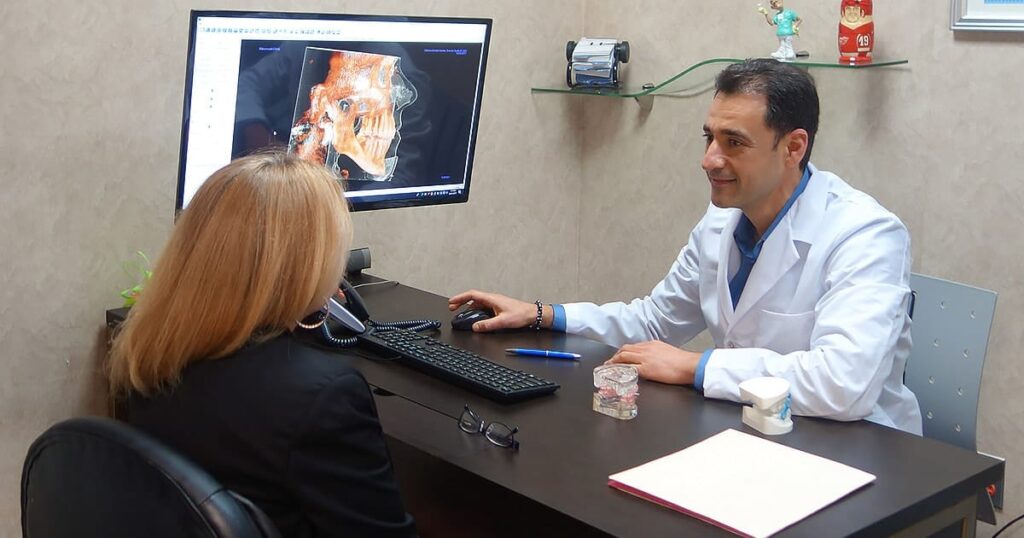 Dr. Sadikoff with a patient in a consultation