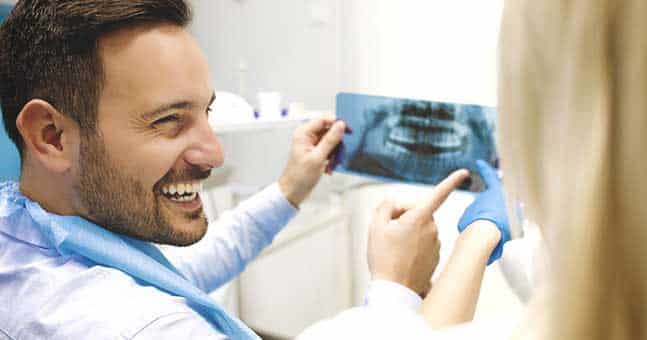 Looking At X-Ray with Orthodontist for Adults in Chesterfield MI