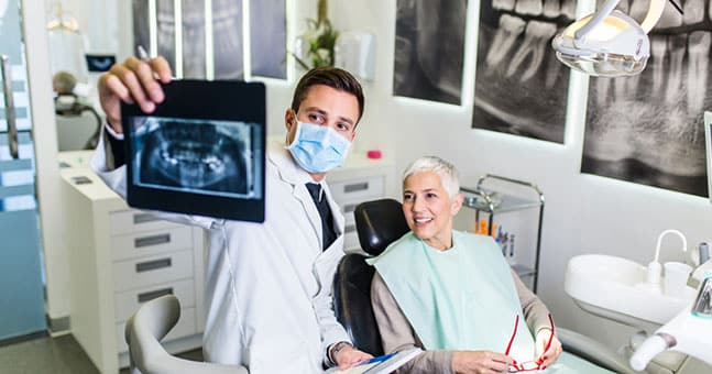 General Dentist in Chesterfield MI Showing X-Rays to A Patient