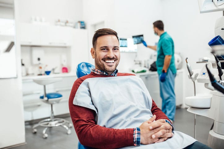 Young good looking man having dental treatment at dentist's office.
