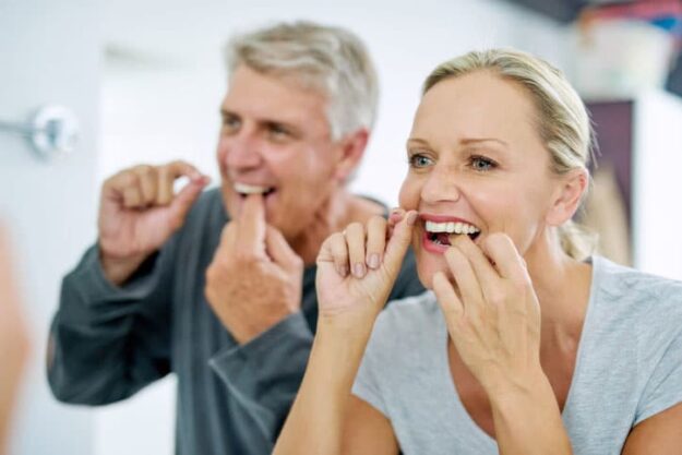 couple-flossing-gums