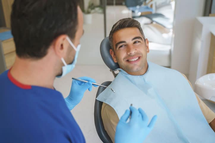 Dentist Telling Patient About Oral Crown Care