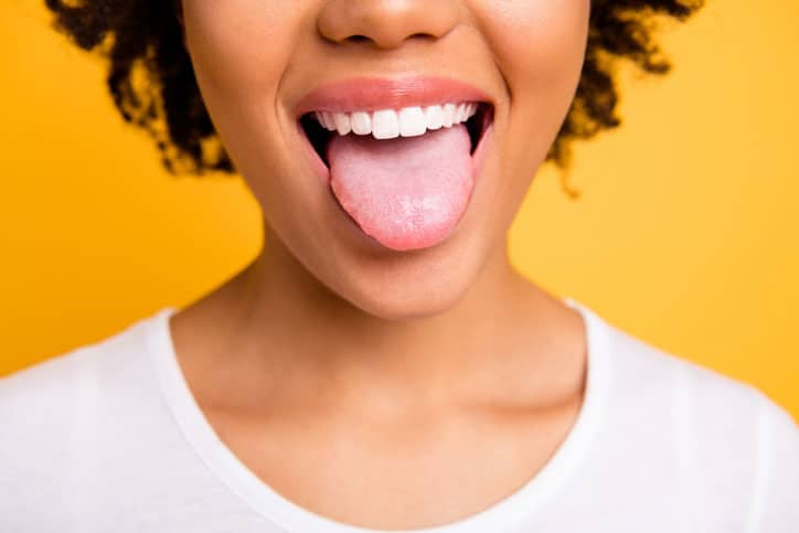 Orange background black woman with tongue sticking out