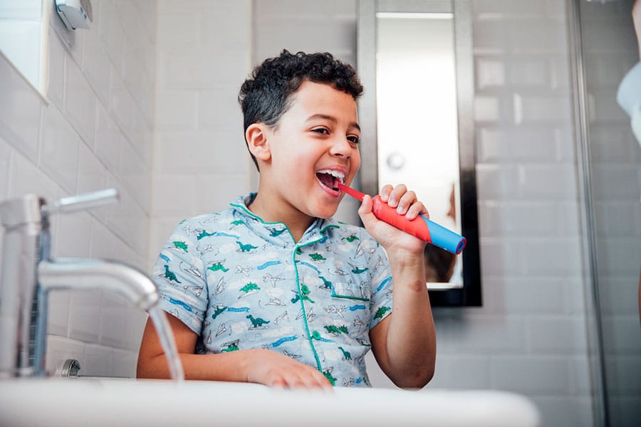 Child Using Electric Toothbrush