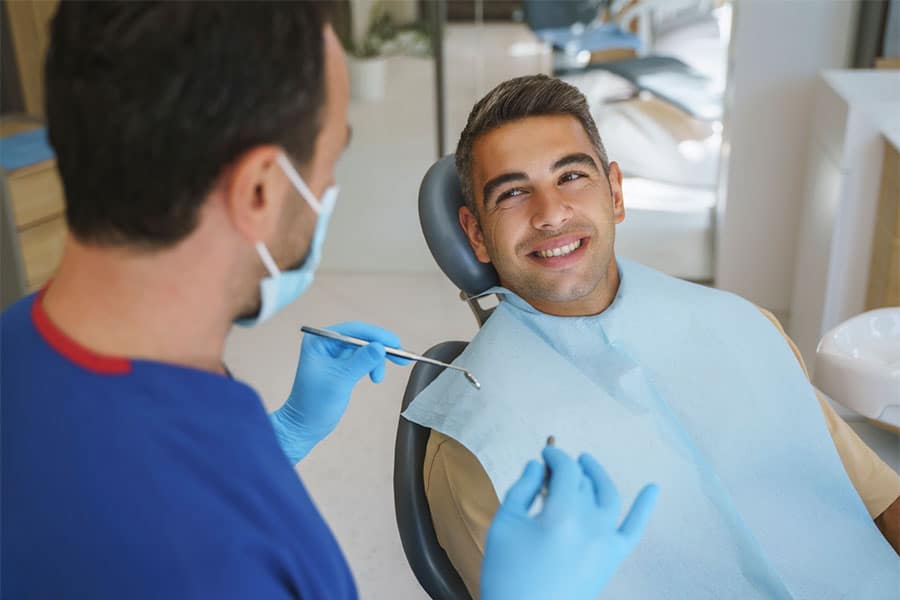 Man Smiling in Dental Chair
